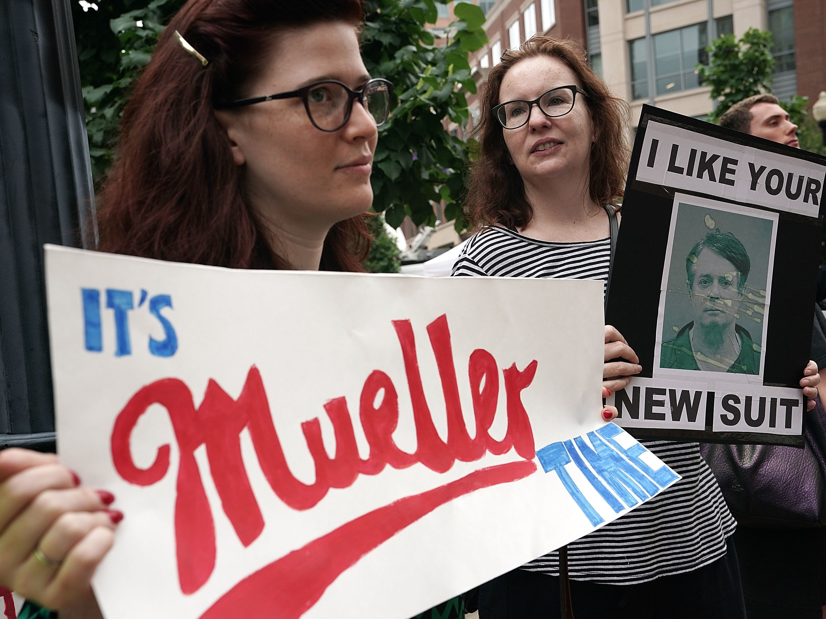 caption: Activists protest outside the federal courthouse in Alexandria, Va., on July 31, 2018, the first day of the trial of former Trump campaign chairman Paul Manafort.
