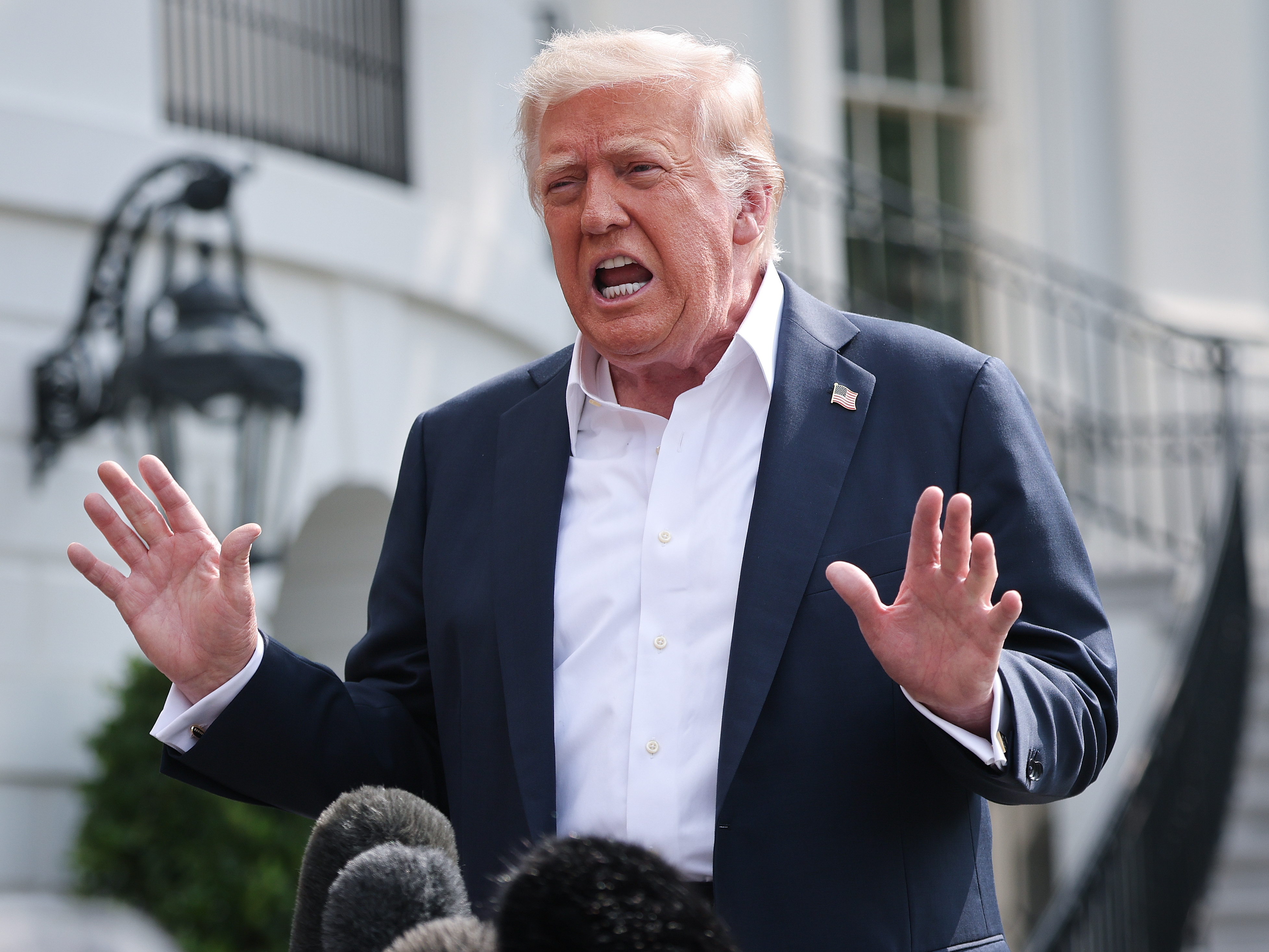 caption: President Trump answers questions at the White House on July 11.