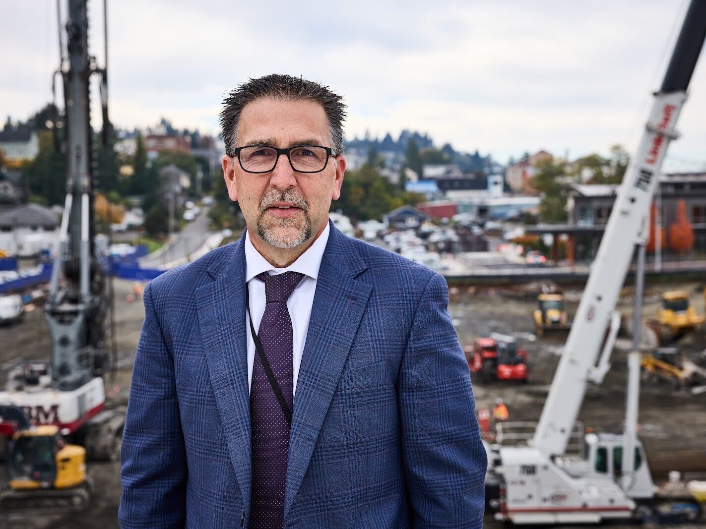 caption: Erik Thorsen, CEO of Columbia Memorial Hospital in Astoria, Ore., stands on the hospital roof overlooking the construction. The project, designed to fortify the building in the event of an earthquake and provide shelter during a tsunami, is proceeding — even without funds promised from the federal government.