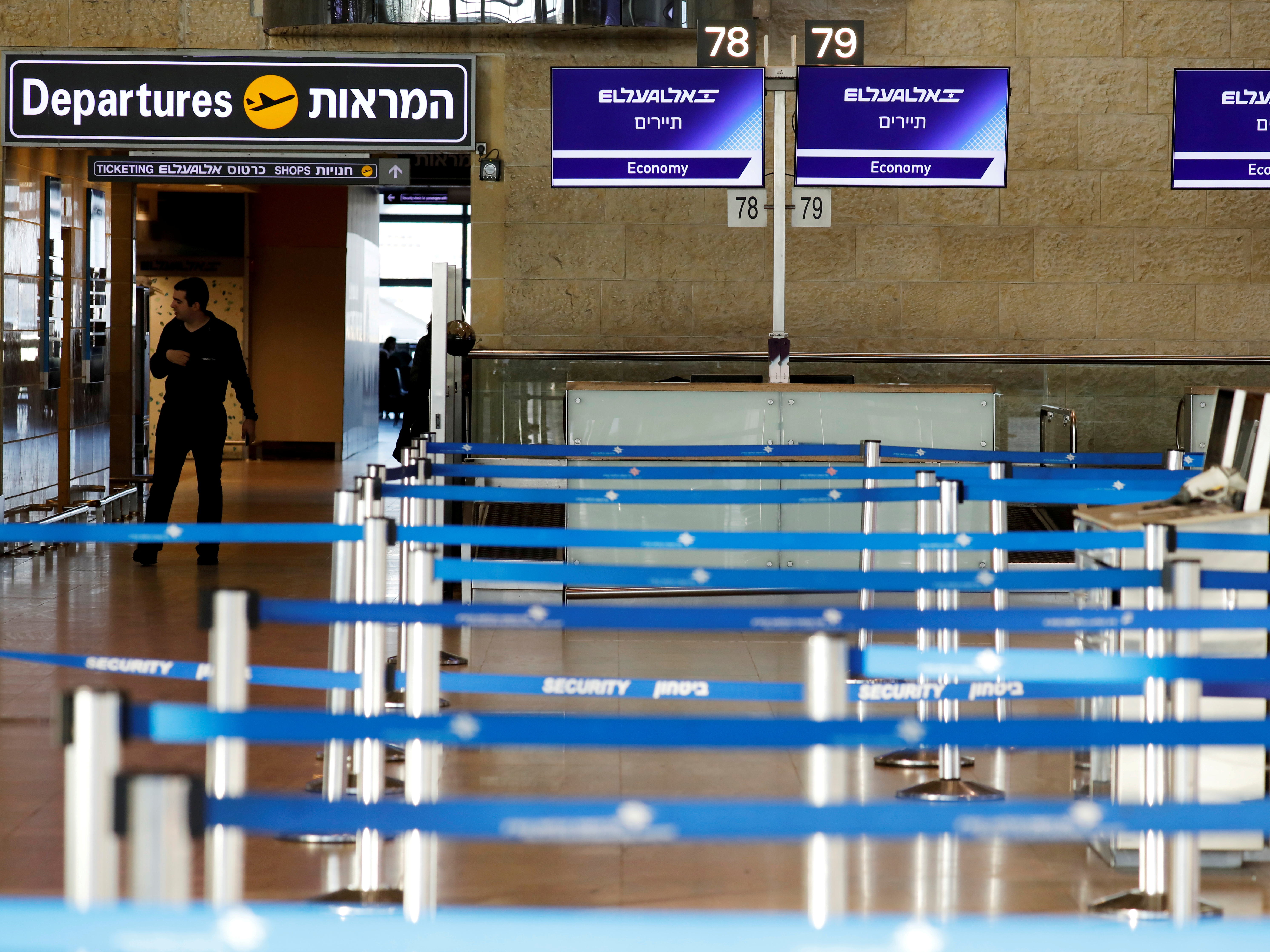 caption: Israel has announced a blanket quarantine policy for anyone entering the country; the policy will be in effect for two weeks. Here, empty airline check-in counters are seen at Ben Gurion Airport, near Tel Aviv.