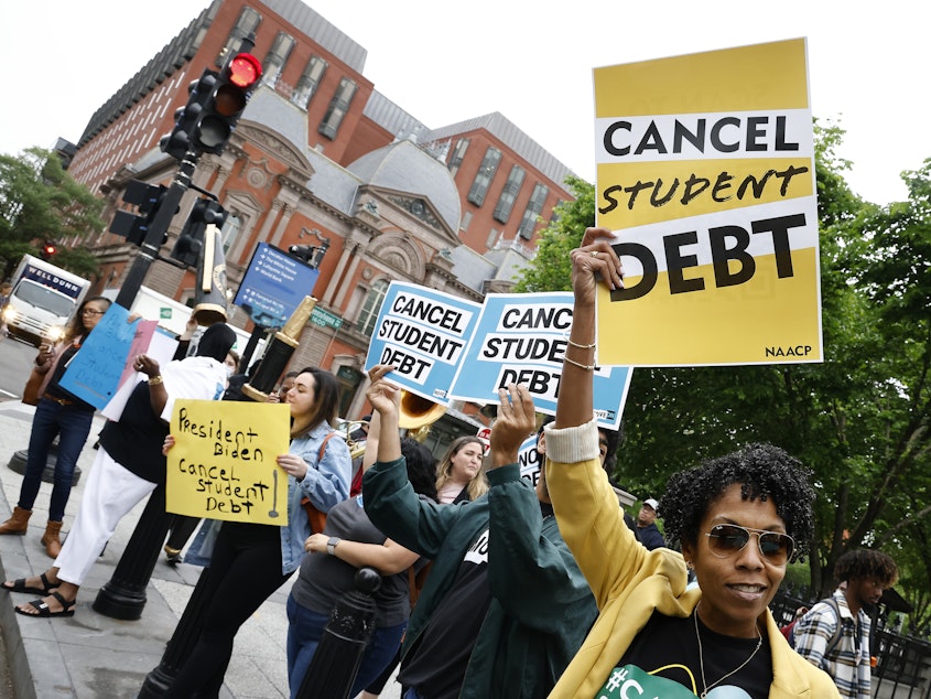 caption: Student loan borrowers gather near The White House in May 2020. On Thursday, the Senate voted to repeal President Biden's plan to offer up to $20,000 in federal student loan debt relief.