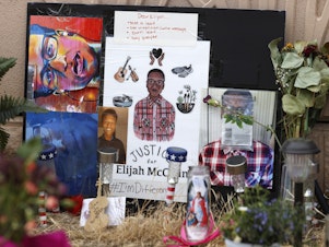 caption: In this July 3, 2020, file photo, a makeshift memorial stands at a site across the street from where Elijah McClain was stopped by police officers while walking home in Aurora, Colo.