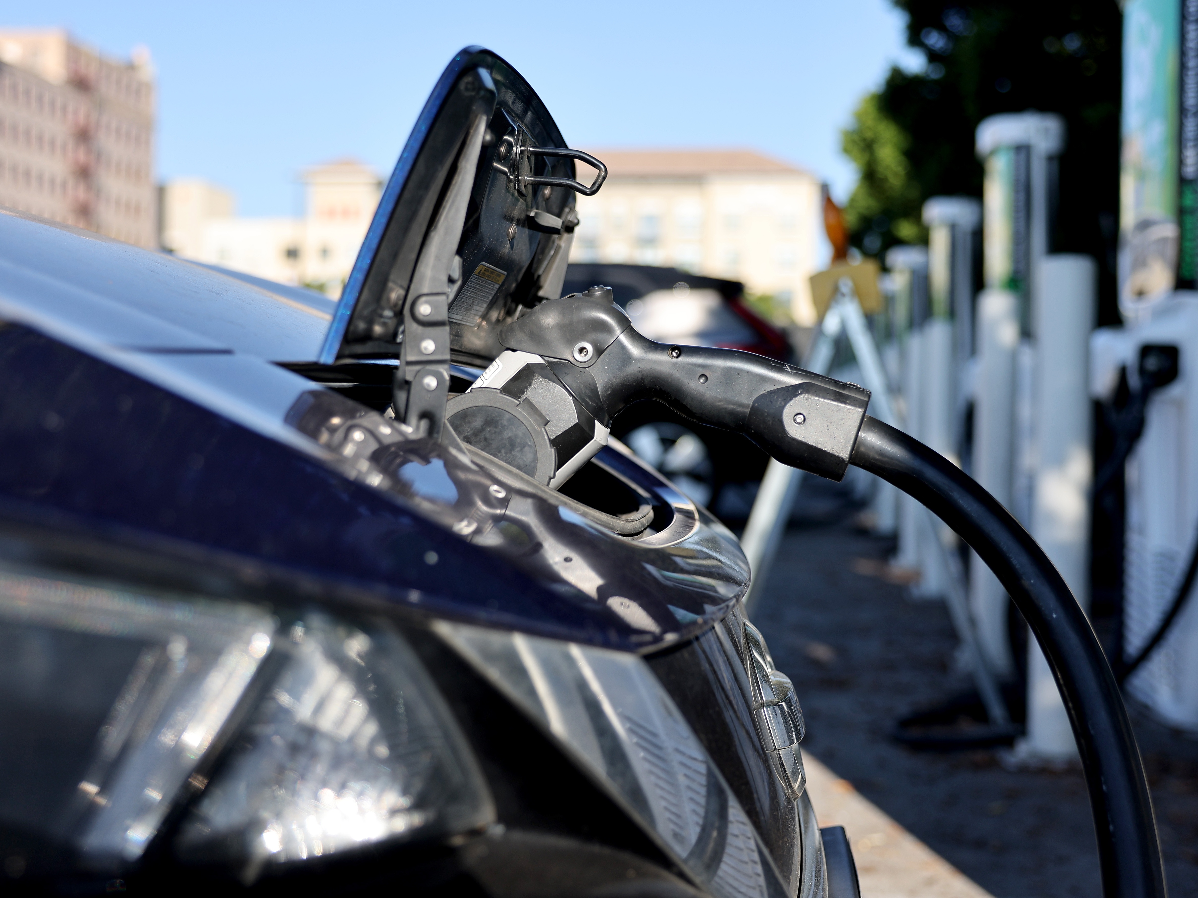 caption: A Nissan LEAF recharges at a station in Pasadena, Calif. Memos obtained by NPR show a key federal agency has paused orders of zero-emission vehicles and some federally-owned EV chargers will be shut off.