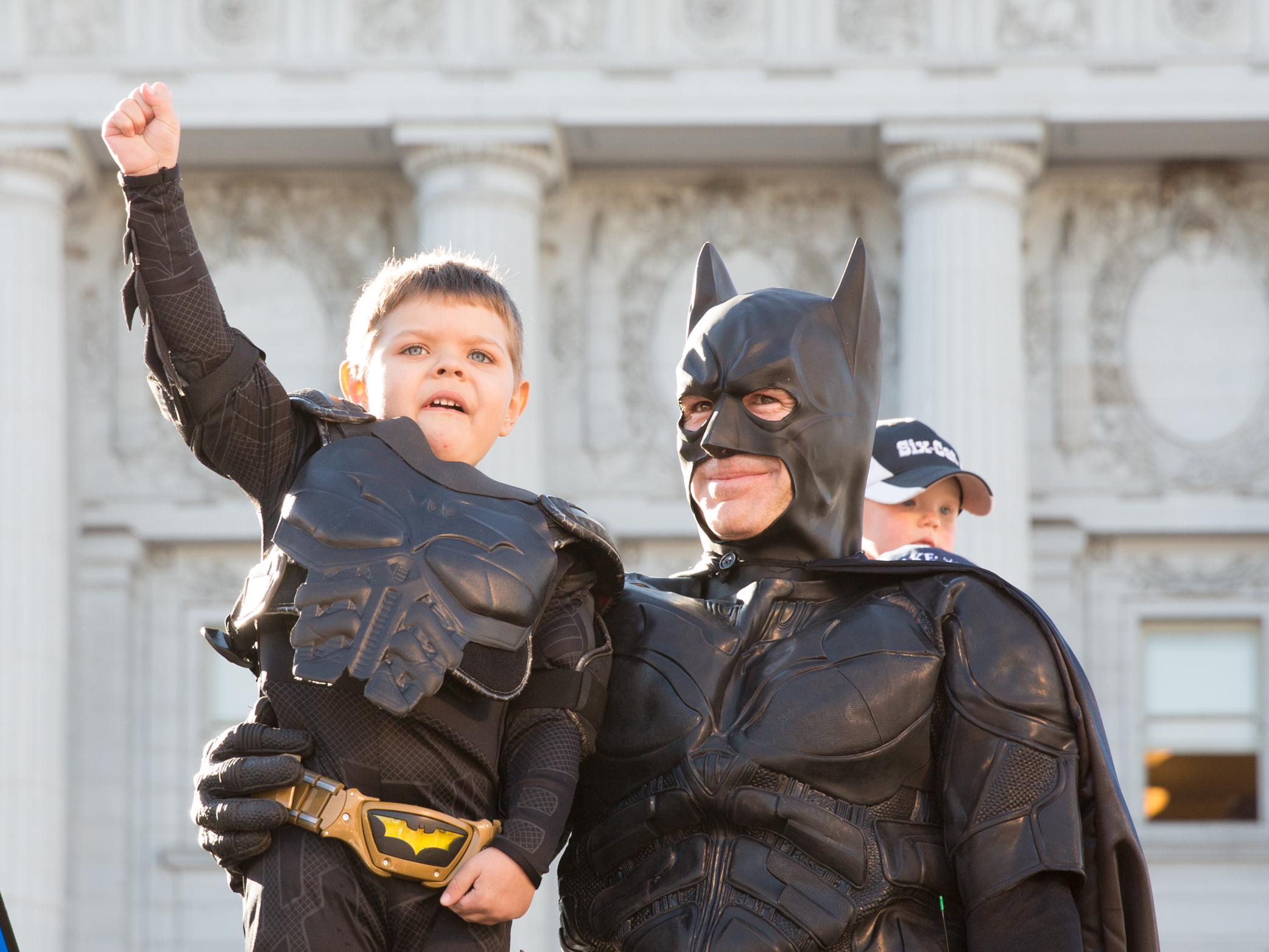 caption: Batkid Miles Scott, center, received a key to the city from San Francisco Mayor Ed Lee, left, on Nov. 15, 2023.
