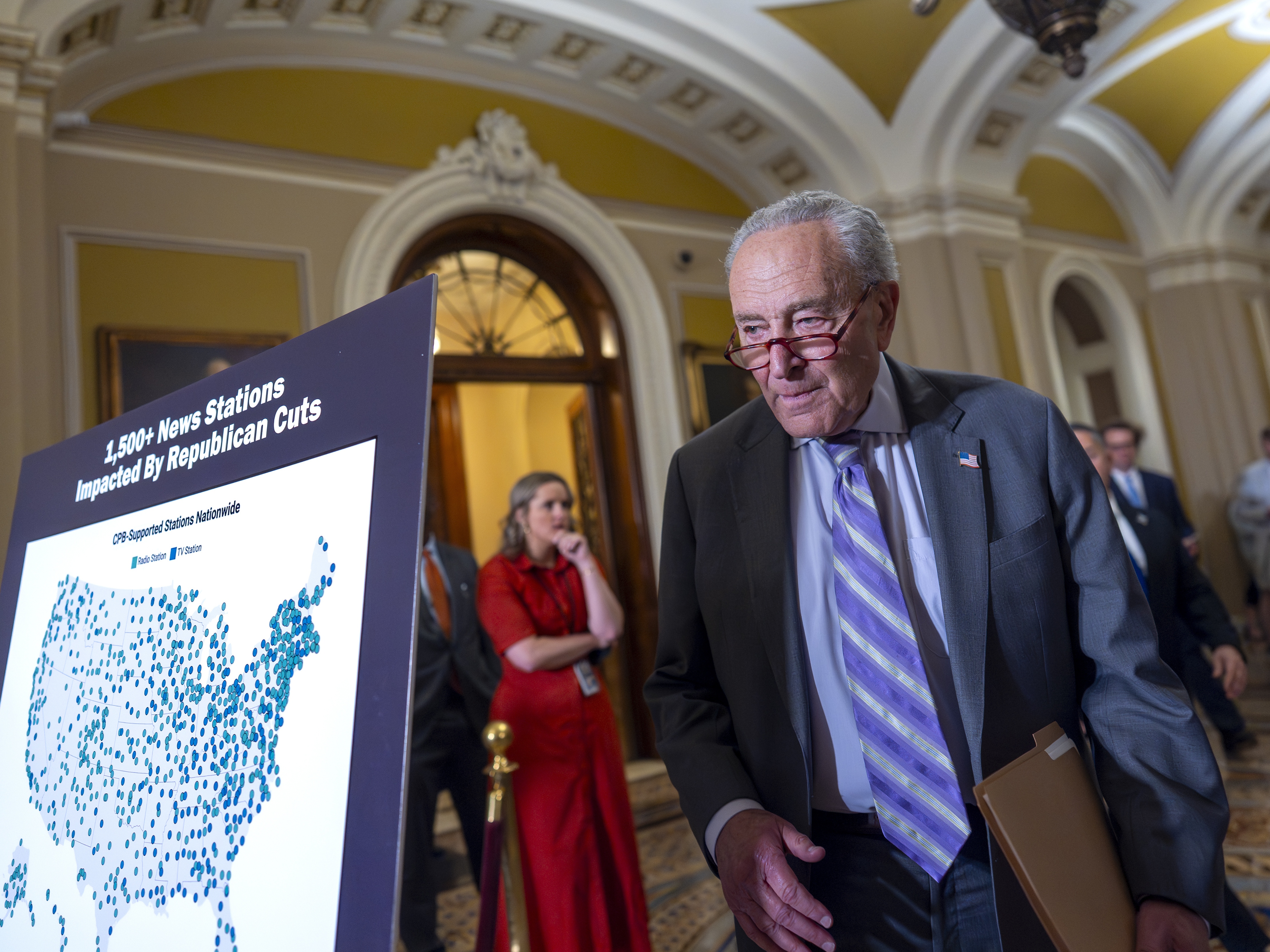 caption: Senate Minority Leader Chuck Schumer, D-N.Y., arrives to speak with reporters about Senate Republicans' efforts to claw back $1.1 billion of funding authority from the Corporation for Public Broadcasting and about $8.3 billion from foreign aid programs targeted by DOGE, at the Capitol in Washington, Tuesday, July 15, 2025.