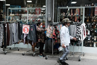 caption: People shop in downtown Brooklyn in May in New York City. The poverty rate dropped in 2020, according to the Census Bureau's supplemental poverty measure.