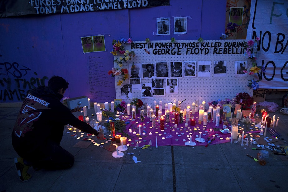 caption: "Rest in power to those killed during the George Floyd Rebellion" reads the wall above a candlelight vigil honoring those killed unjustly at the hands of law enforcement on Tuesday, June 2, 2020, at the intersection of 11th Avenue and East Pine Street in Seattle. 