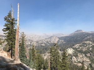 caption: Smoke from the Lions Fire obscures granite peaks in the Sierra Nevada. CREDIT: NATHAN ROTT
