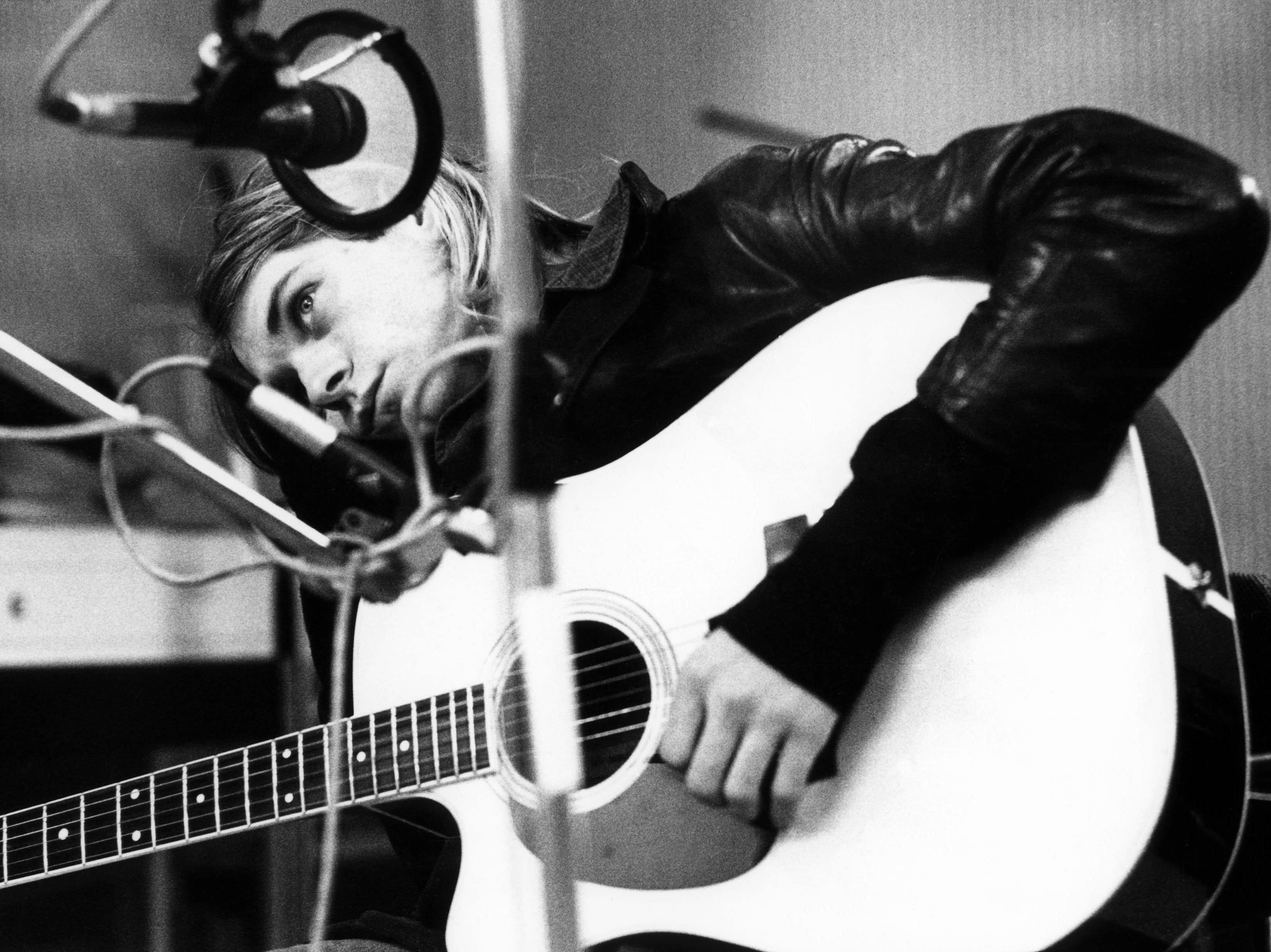 caption: Kurt Cobain in the studio with Nirvana in late 1991.