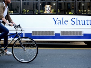caption: A former Yale University administrator has pleaded guilty to a years-long scheme of stealing electronics ordered for the university and reselling the items. Here, a shuttle drives students around Yale's campus.
