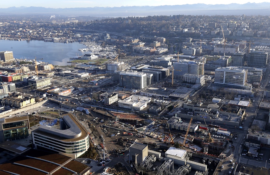 caption: In this Jan. 29, 2015, photo, Seattle's South Lake Union neighborhood is shown dotted with construction cranes and new buildings as viewed from the top of the Space Needle. 