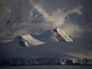 caption: A view of the glaciers and mountains from the Gerlache Strait on the western side of the Antarctic Peninsula in February 2022.