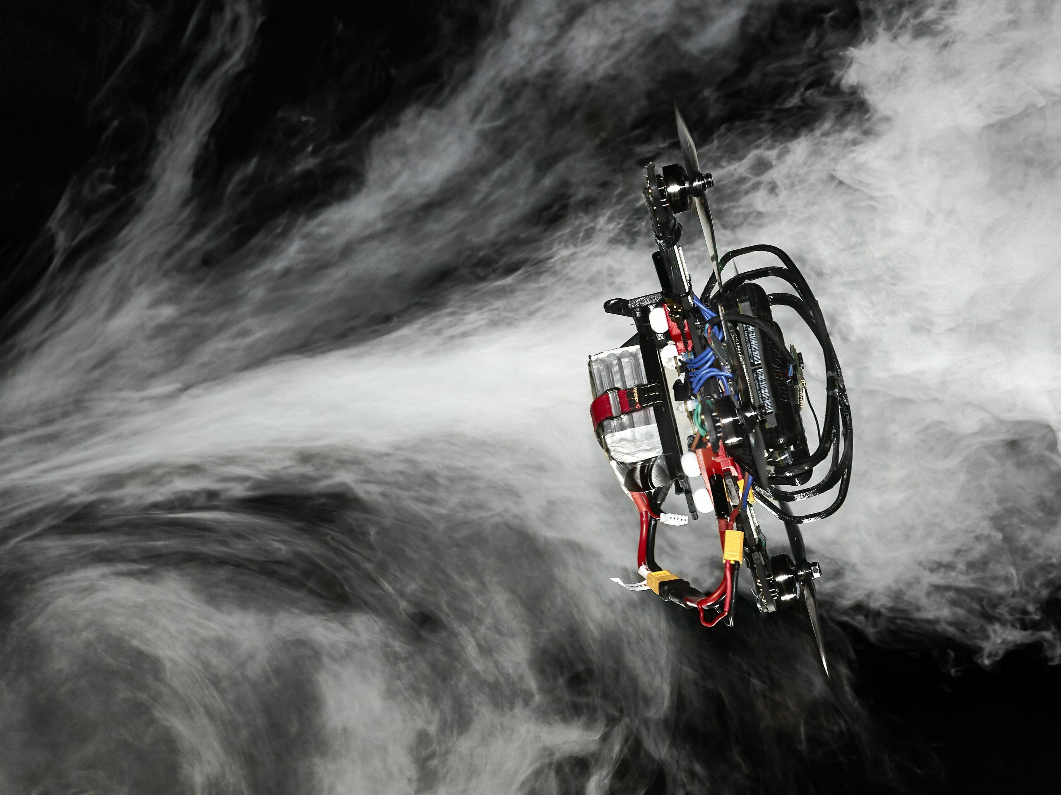 caption: The drone uses a mix of artificial intelligence and more conventional programming to fly through a race course.