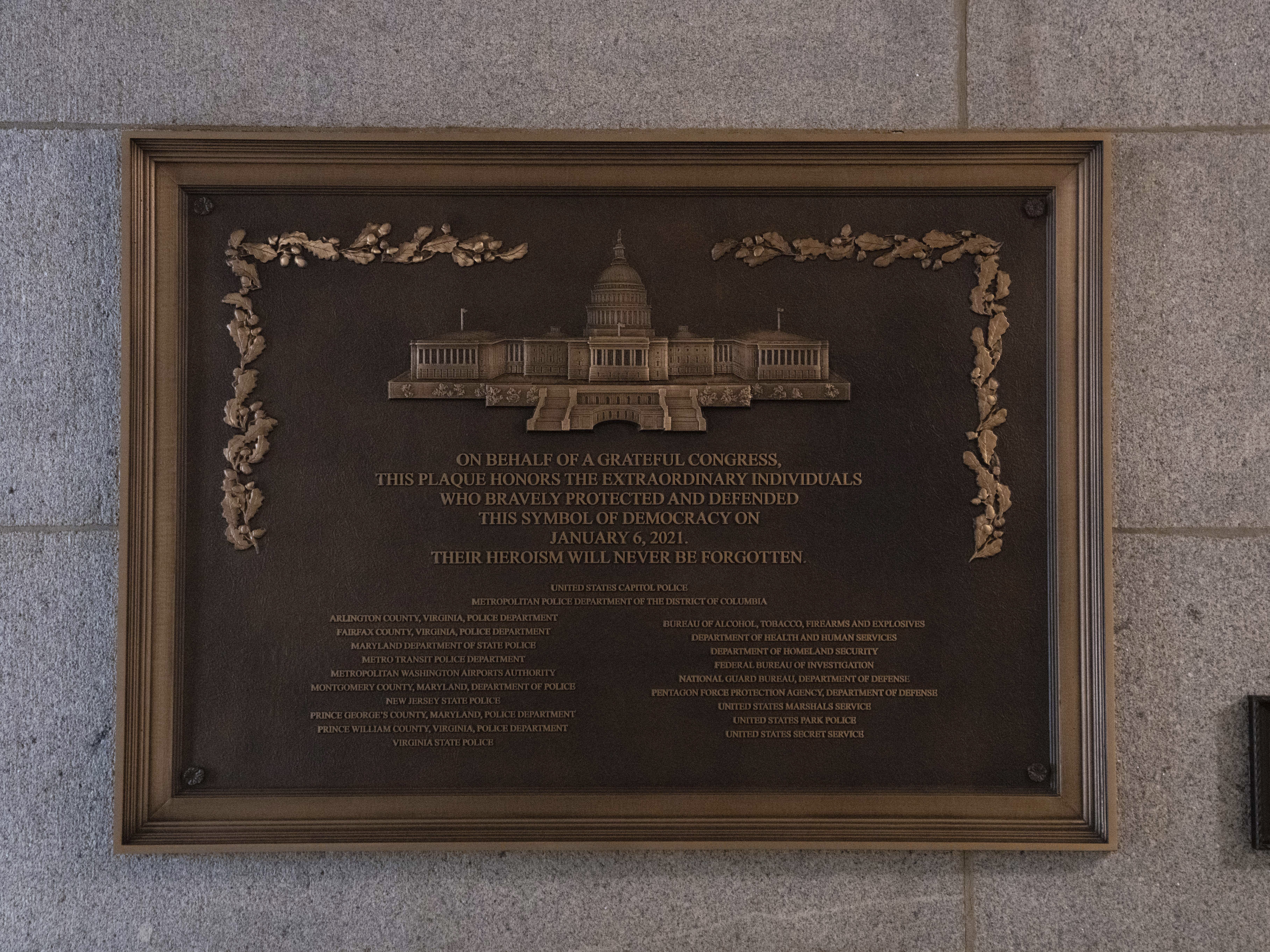 caption: A plaque honoring police service on Jan. 6, 2021 at the Capitol, Saturday, March 7, 2026, in Washington.