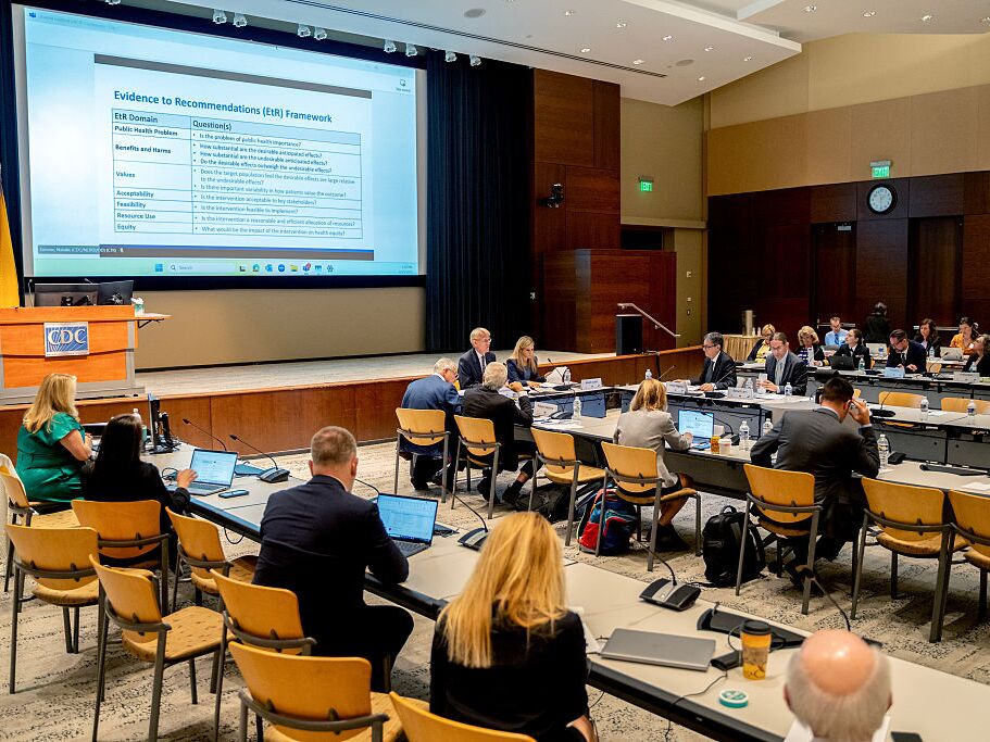 caption: Members of the Advisory Committee on Immunization Practices meet at the Centers for Disease Control and Prevention headquarters in Atlanta, Ga. in June.
