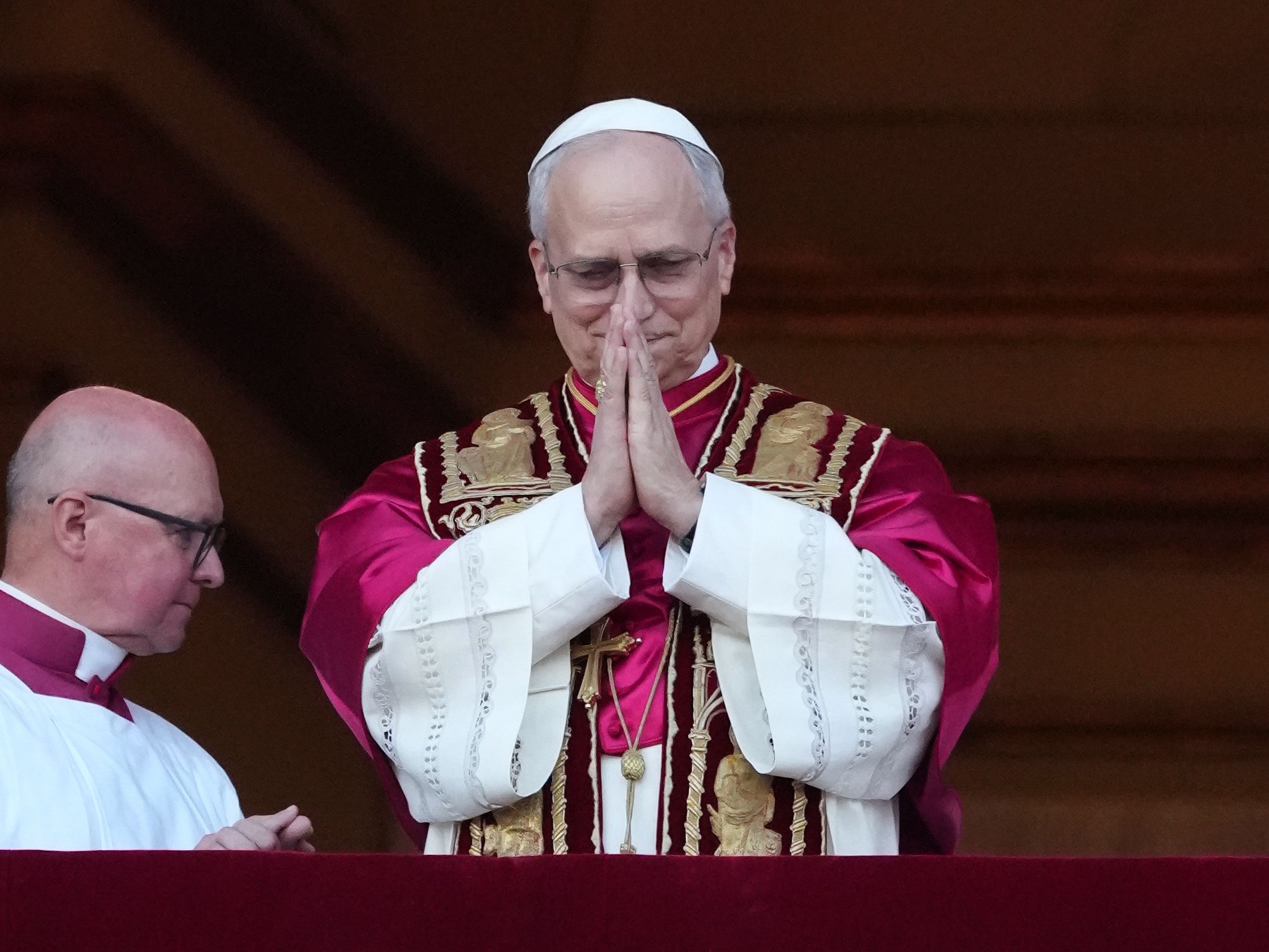 caption: The newly elected Pontiff, Pope Leo XIV is seen for the first time from the Vatican balcony on May 8 in Vatican City, Vatican.