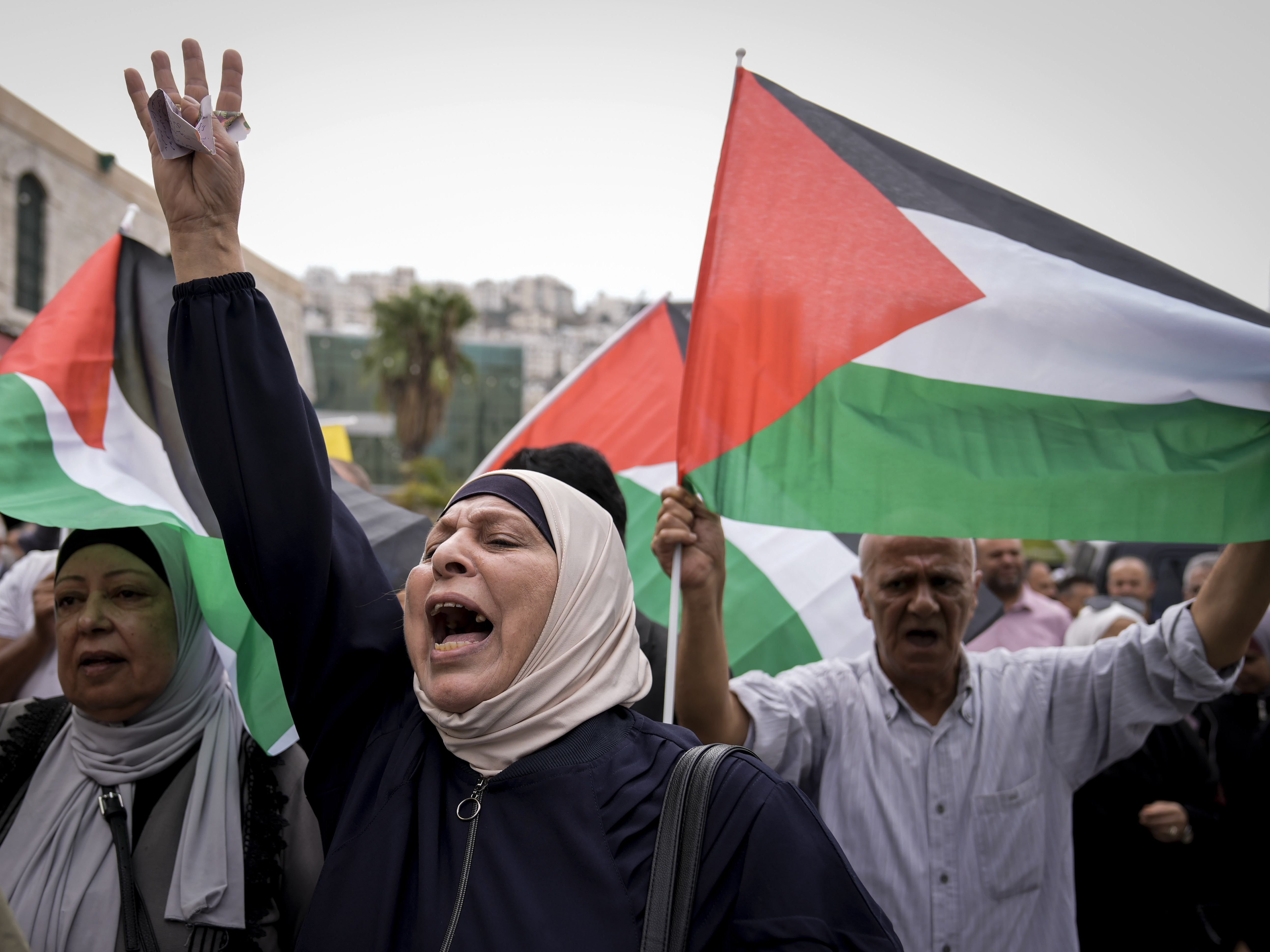 caption: Palestinians attend a rally in support of Hamas and the Gaza Strip in the West Bank city of Nablus on Monday.