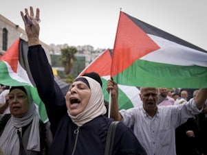 caption: Palestinians attend a rally in support of Hamas and the Gaza Strip in the West Bank city of Nablus on Monday.