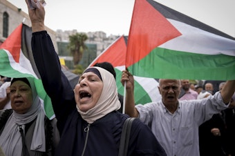 caption: Palestinians attend a rally in support of Hamas and the Gaza Strip in the West Bank city of Nablus on Monday.
