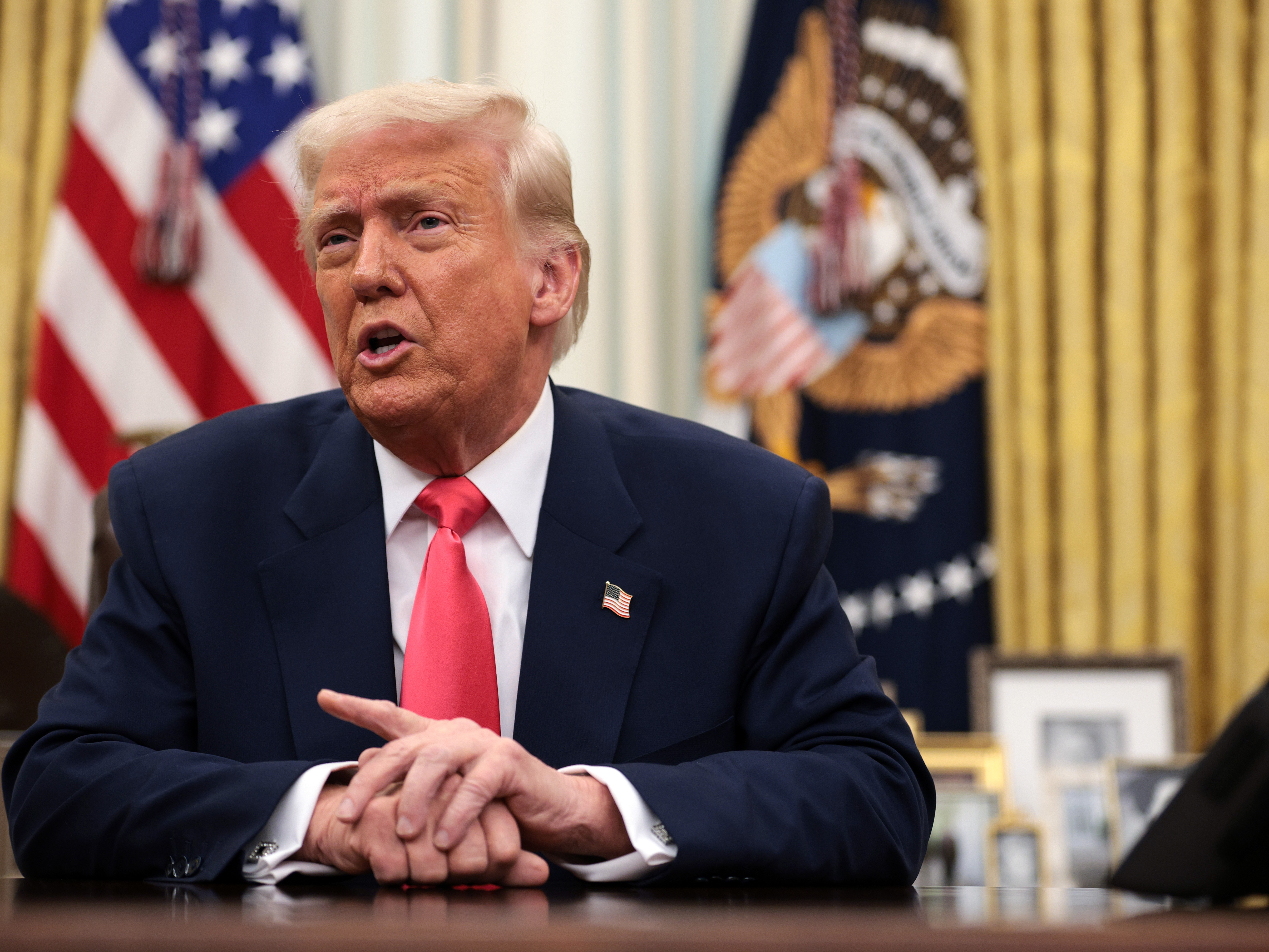 caption: President Trump speaks before signing executive orders in the Oval Office on March 6.