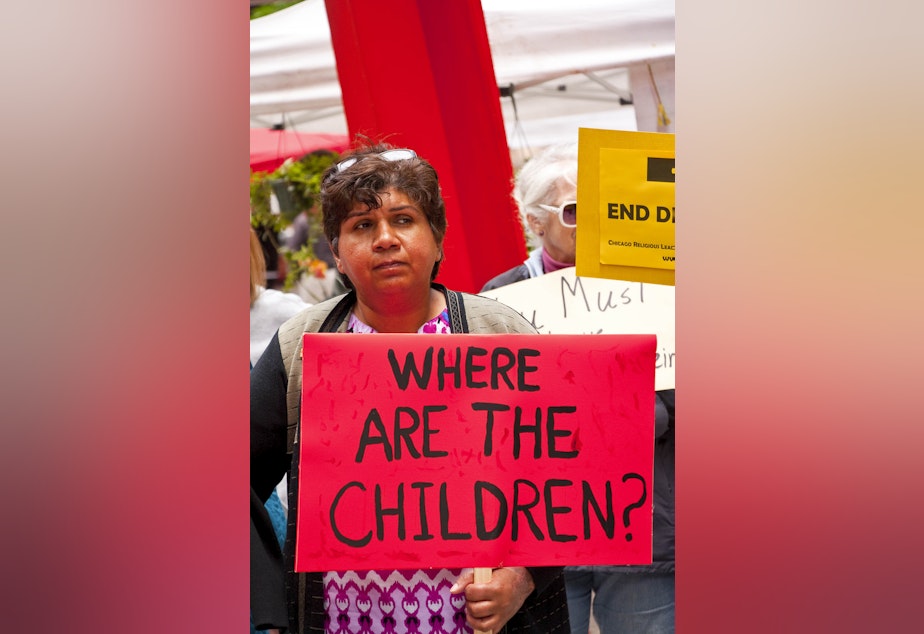 caption: A woman holds a sign asking "Where are the children?" at the Stop Separating Immigrant Families Press Conference and Rally in Chicago on June 5th, 2018.