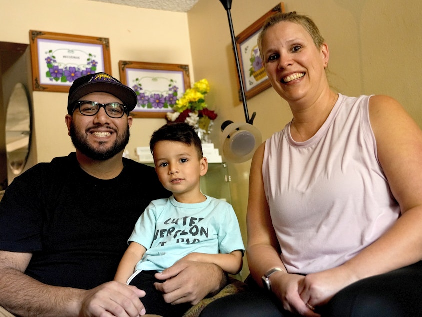 caption: Alicia Celaya, David Cardenas and their son Adrian, 3, in Phoenix in April. Celaya and her family will lose their Medicaid coverage later this year, a result of a year-long nationwide review of the Medicaid enrollees that will require states to remove people whose incomes are now too high for the program.