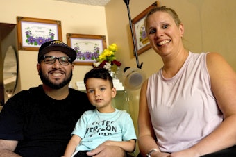 caption: Alicia Celaya, David Cardenas and their son Adrian, 3, in Phoenix in April. Celaya and her family will lose their Medicaid coverage later this year, a result of a year-long nationwide review of the Medicaid enrollees that will require states to remove people whose incomes are now too high for the program.