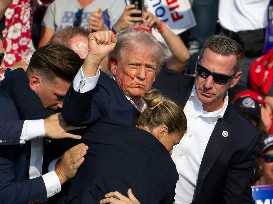 caption: Republican candidate Donald Trump is surrounded by Secret Service agents following an attempted assassination attempt in in Butler, Pa., on July 13. The head of the Secret Service will appear before lawmakers Monday to discuss the agency's actions before, during and after the incident.