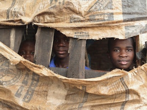 caption: Children in a makeshift shelter near Harare, Zimbabwe. Cyclone Idai has displaced thousands in southern Africa.