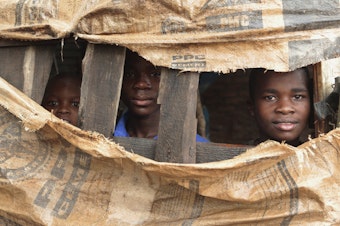 caption: Children in a makeshift shelter near Harare, Zimbabwe. Cyclone Idai has displaced thousands in southern Africa.