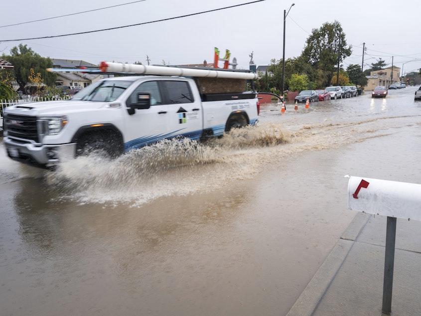 caption: A truck is driven through a flooded intersection of Salinas, Calif., on Tuesday. The first in a week of storms brought gusty winds, rain and snow to California on Tuesday, starting in the north and spreading southward.