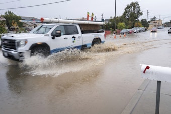 caption: A truck is driven through a flooded intersection of Salinas, Calif., on Tuesday. The first in a week of storms brought gusty winds, rain and snow to California on Tuesday, starting in the north and spreading southward.