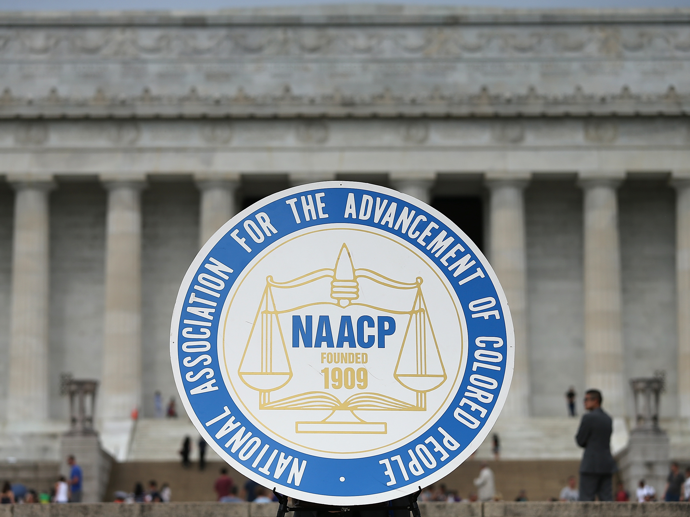 caption: The NAACP logo is shown during an event at the Lincoln Memorial in Washington, D.C., in 2015. The civil rights group has announced it won't invite President Trump to address its convention, breaking a 116-year tradition of inviting sitting presidents.