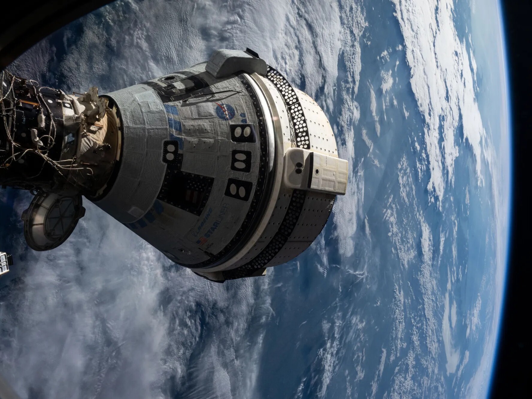 caption: This view from the SpaceX Dragon Endeavour spacecraft shows Boeing's Starliner docked to the International Space Station on July 3, 2024.