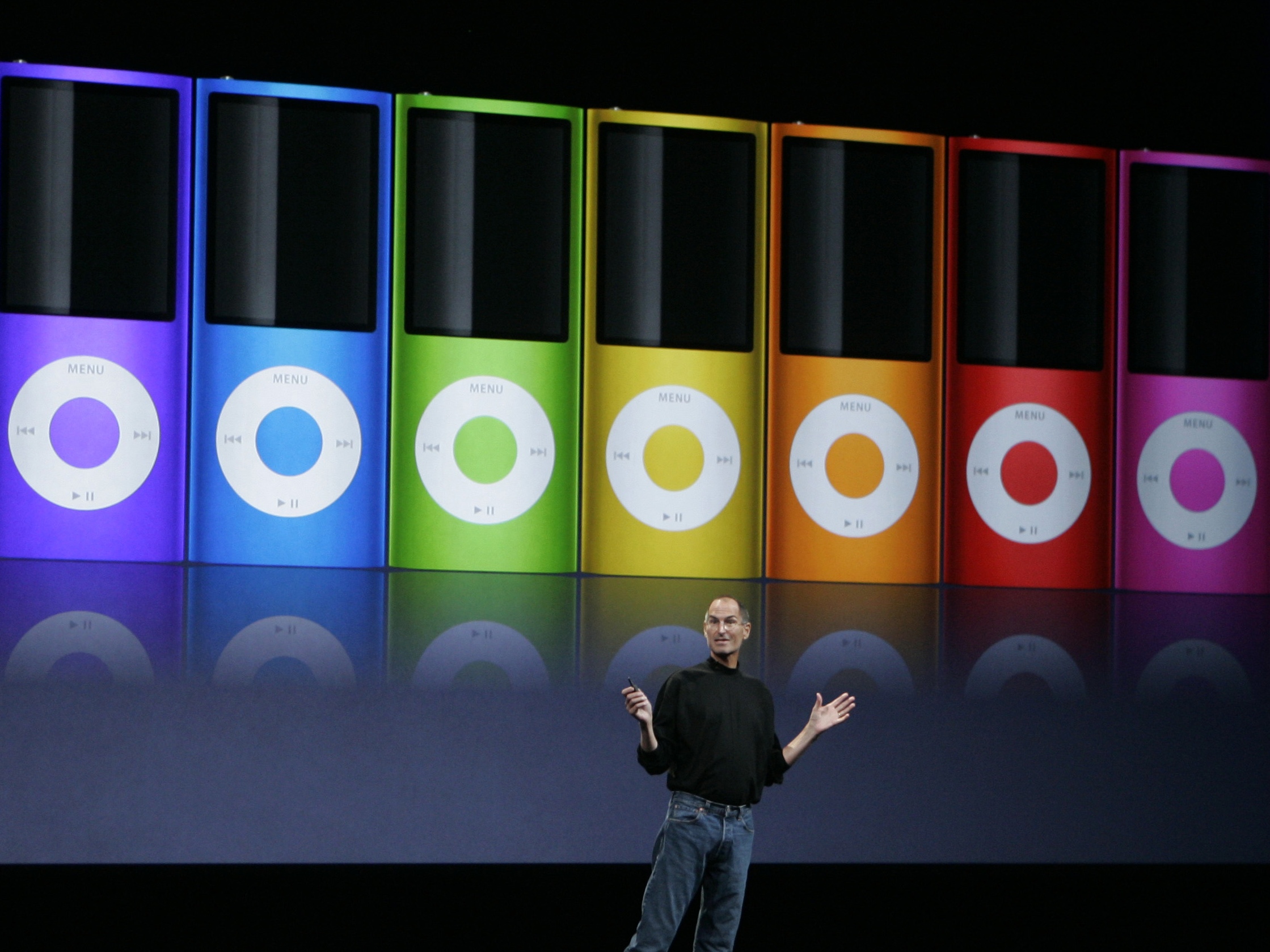 caption: Apple's then-CEO, Steve Jobs, introduces new colors for the iPod Nano during a product announcement in San Francisco in September 2008.