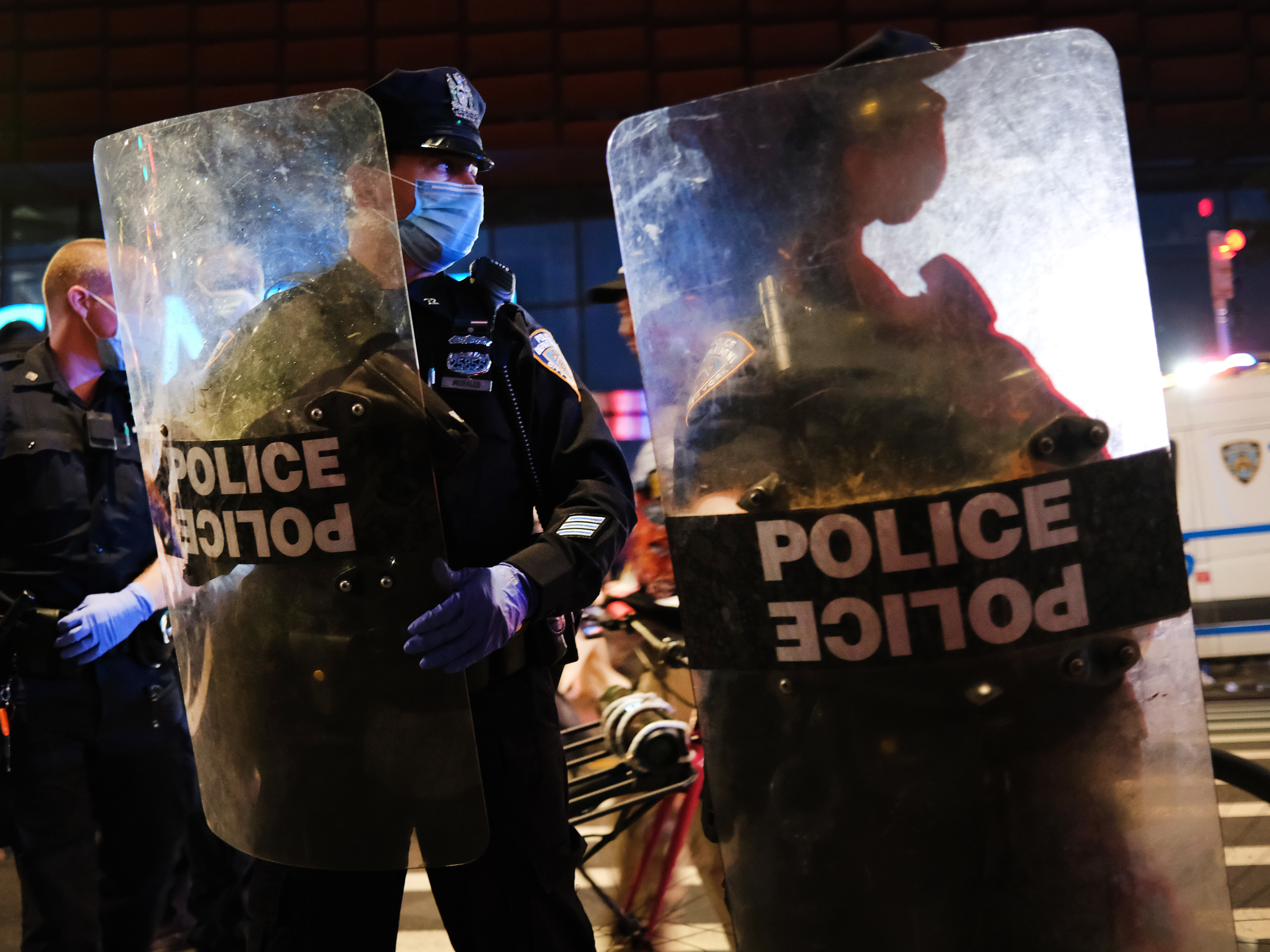 caption: Police confront protesters in front of the Barclays Center in Brooklyn, NY, on May 29, 2020.