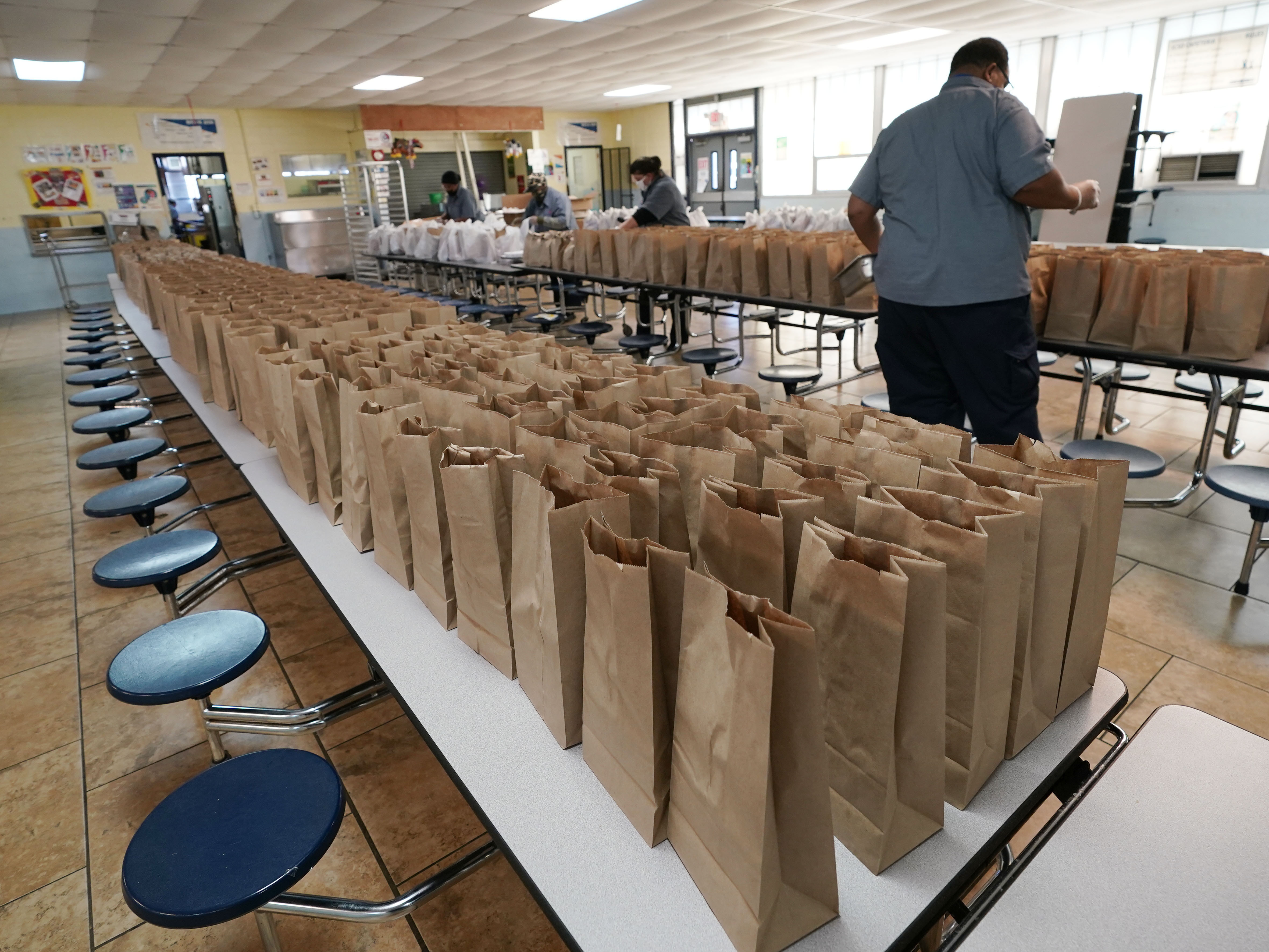 caption: Jefferson County School District Food Service Department staff arrange some of the hundreds of free lunches that was given to students on March 3, 2021 in Fayette, Miss. As one of the most food insecure counties in the United States, many families and their children come to depend on the free meals as their only means of daily sustenance.