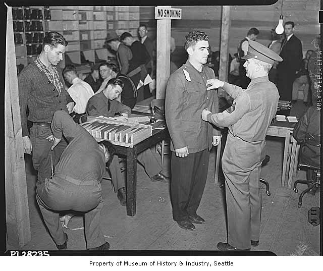 caption: Army recruits in Seattle being fitted for uniforms after the Pearl Harbor attack, 1941.