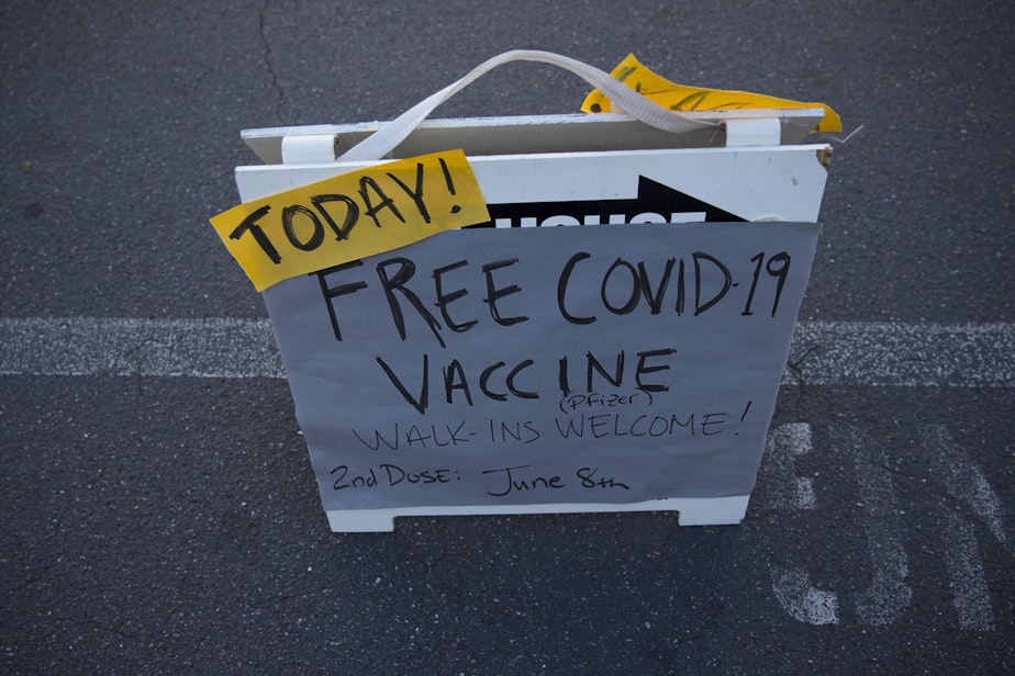 caption: A sign reads 'Today! Free Covid-19 Vaccine' outside of a vaccine clinic for students over the age of 12 on Tuesday, May 18, 2021, at Memorial Stadium in Seattle.