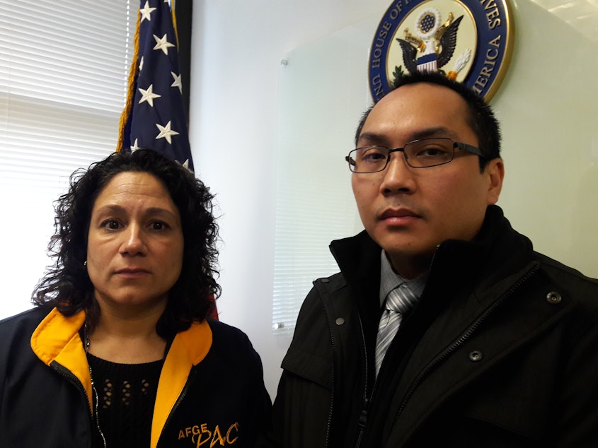 caption: Angie Tucker with co-worker Harold Britt. Both work at the federal detention center at SeaTac.