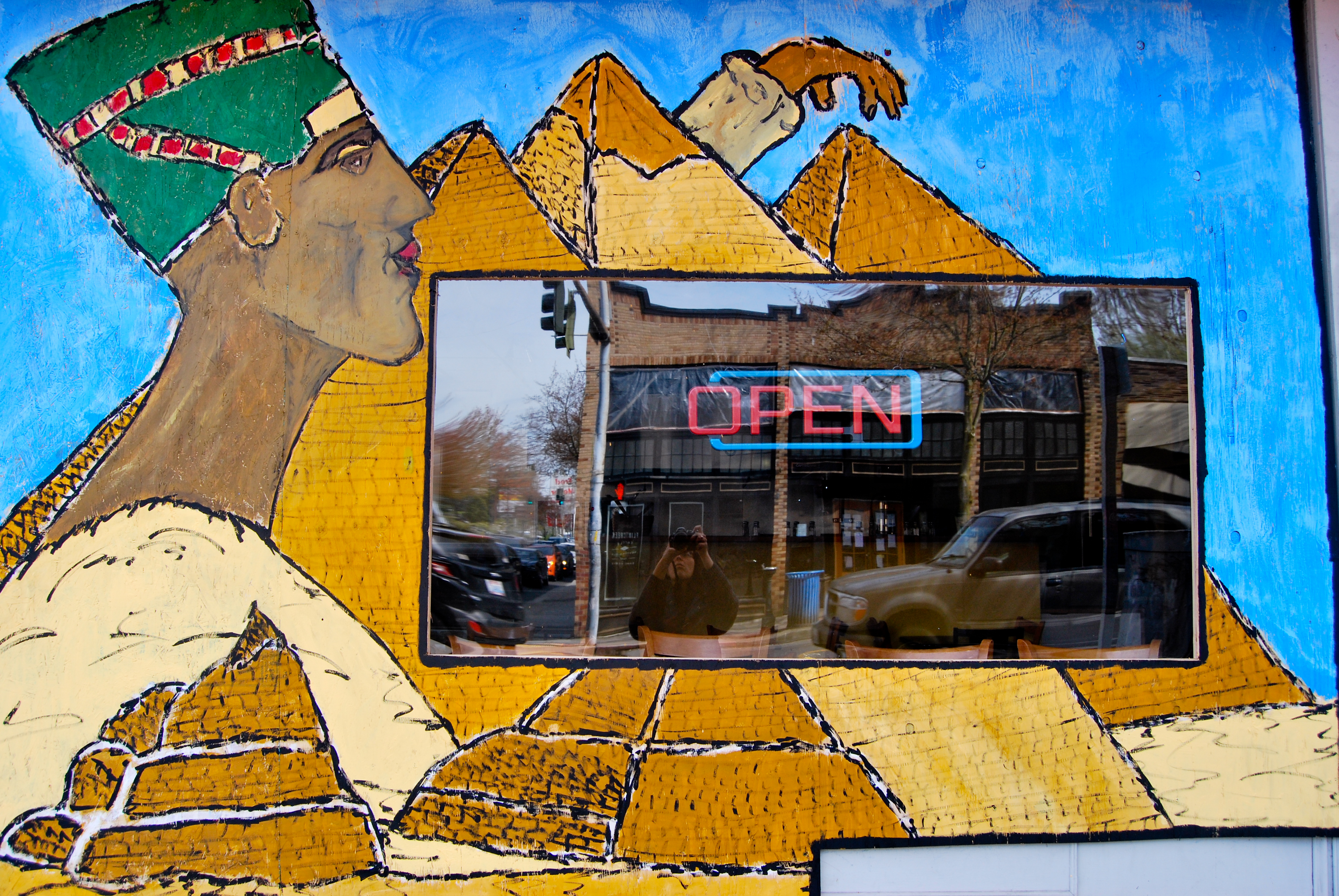 caption: The mural at Hummus Cafe, at North 85th Street and Greenwood Avenue North. Across the street, a similar restaurant, Mr. Gyro, was demolished by the blast.