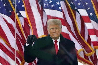 caption: Then-President Donald Trump gestures as he arrives to speak at a rally in Washington, D.C., on Jan. 6, 2021.