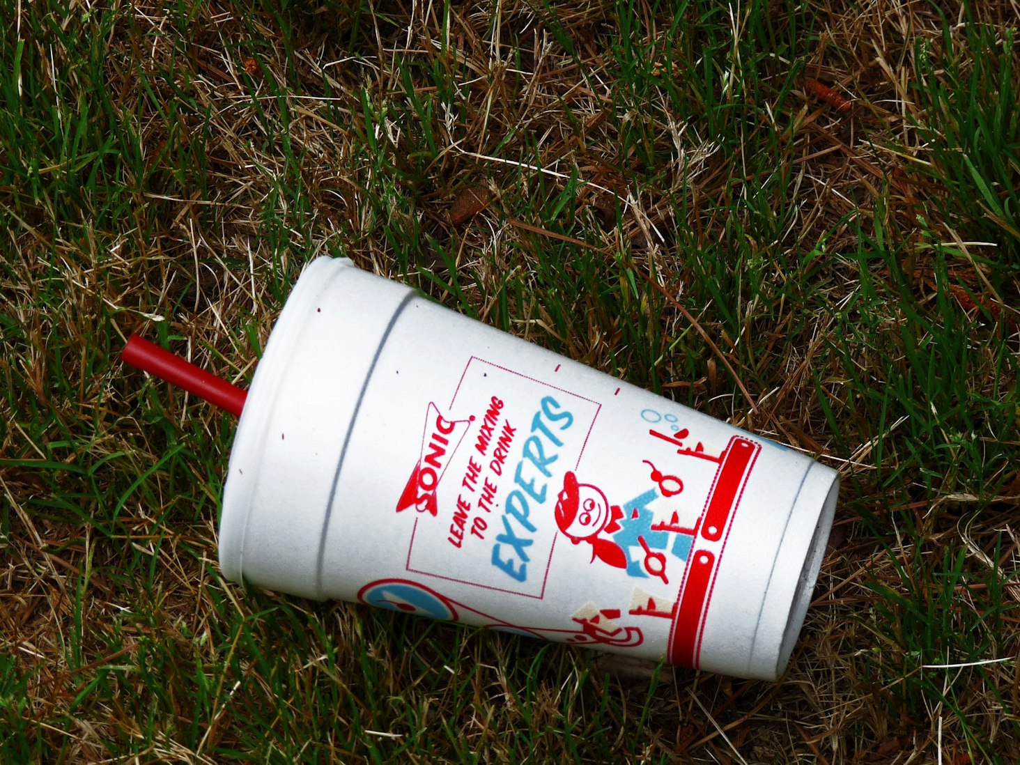 A polystyrene foam cup from the Sonic restaurant chain litters the ground