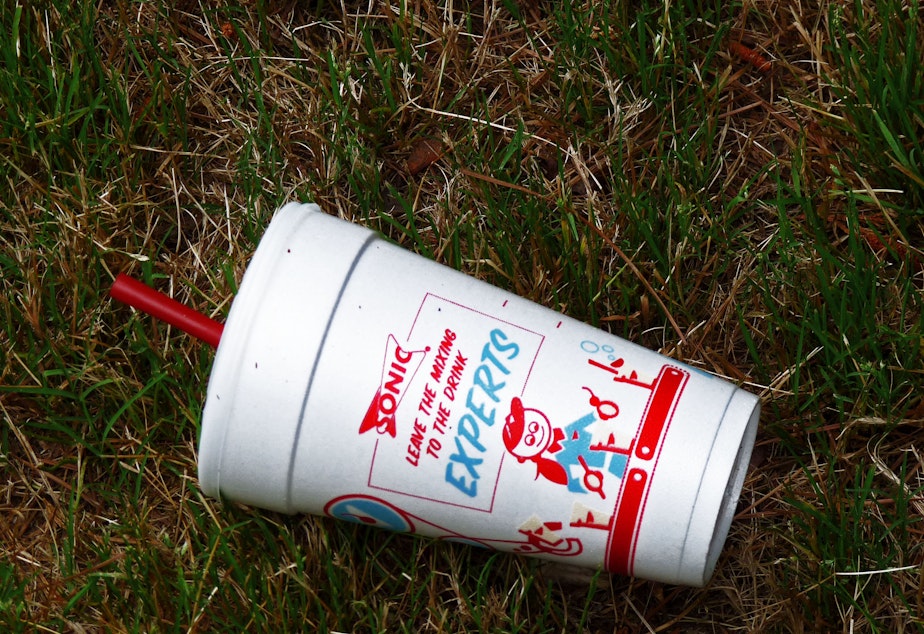 caption: A polystyrene foam cup from the Sonic restaurant chain litters the ground.