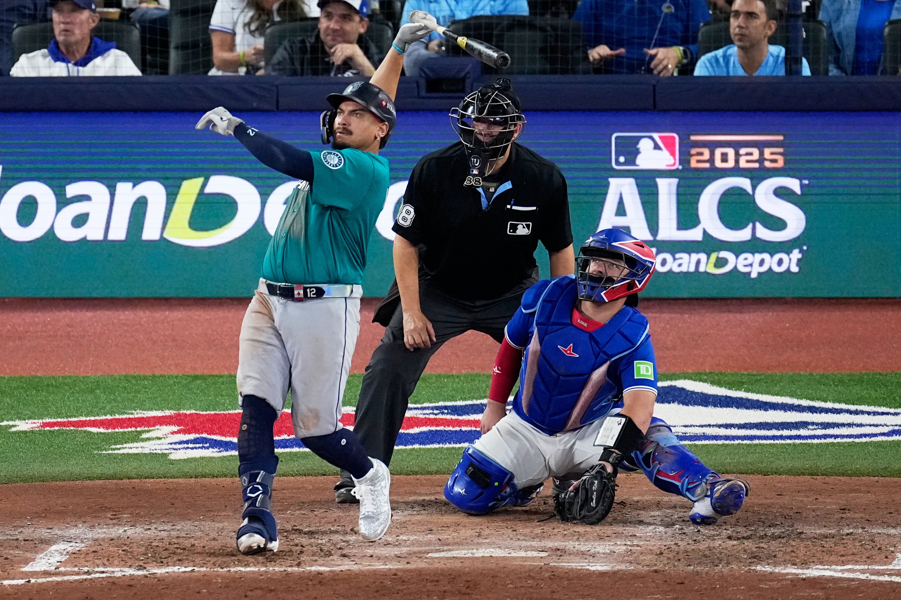 caption: Seattle Mariners' Josh Naylor watches his two run home run leave the park against the Toronto Blue Jays during the seventh inning in Game 2 of baseball's American League Championship Series, Monday, Oct. 13, 2025, in Toronto.