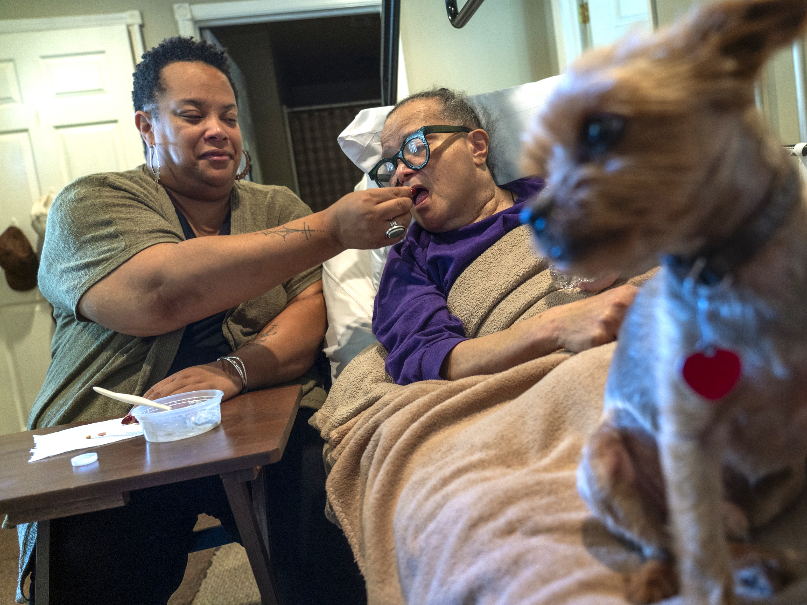 caption: Dawn Shedrick, left, is one of roughly 106 million unpaid caregivers in the U.S. For 30 years, Shedrick taken care of her mother, Nathalia Shedrick, right, who has multiple sclerosis.