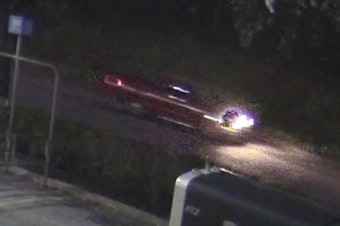 caption: An image taken from surveillance video of a pickup whose driver, according to authorities, fired several shots into a car carrying a family near Houston, killing a 7-year-old girl.