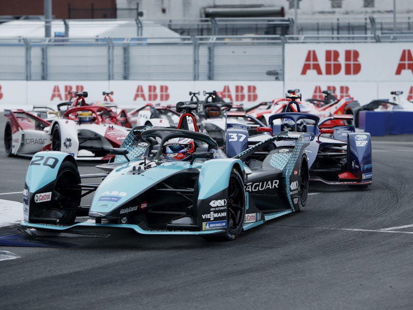 caption: Major automakers like Jaguar develop all-electric race cars to compete in Formula E. Here Mitch Evans, in a Jaguar, leads rivals during the ABB FIA Formula E Championship in New York City on July 11.