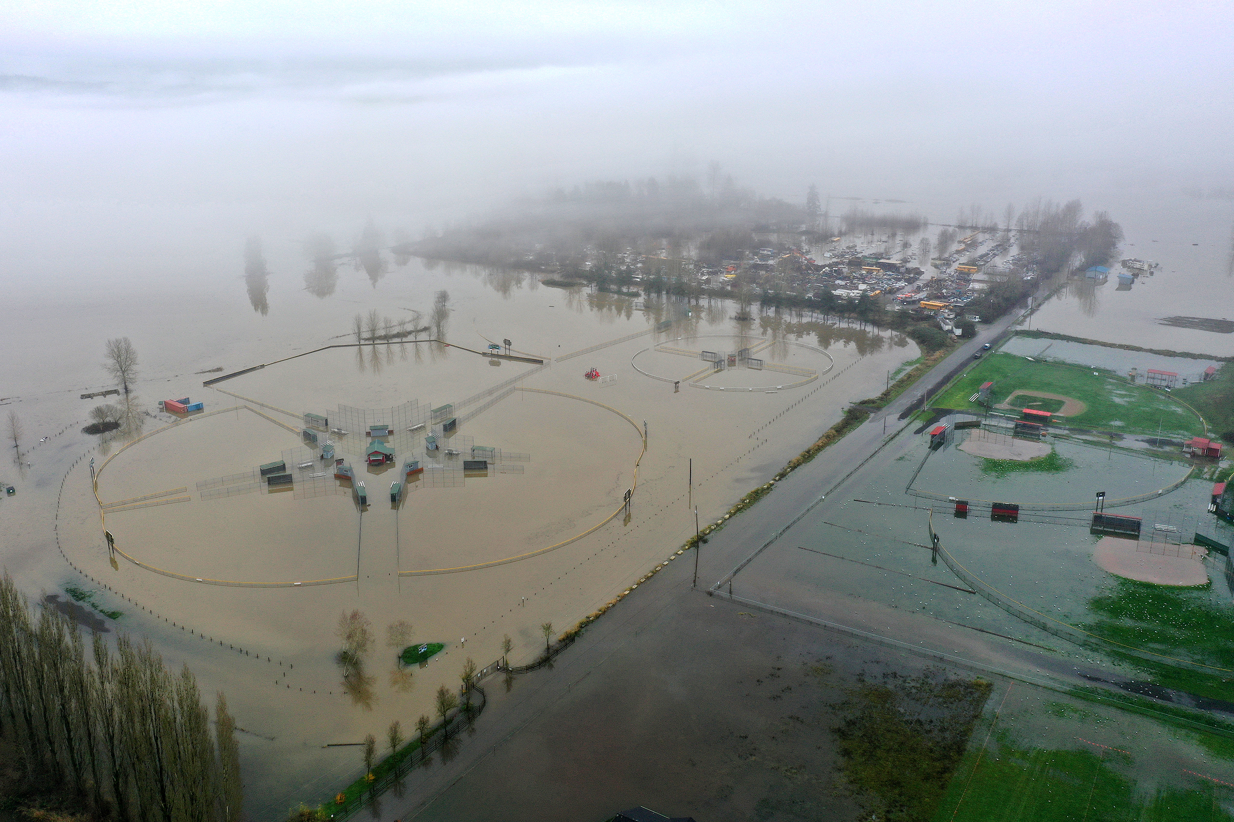 caption: Flooded sports fields are shown along 15th Avenue Northeast near the Snohomish River on Friday, December 12, 2025, in Snohomish. 
