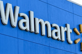 caption: A Black man in Portland, Ore., has been awarded $4.4 million in a settlement after a jury determined he was racially profiled while shopping at Walmart. Here, the Walmart logo is seen outside a store in Burbank, Calif.